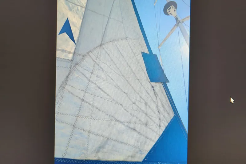 Slide: The Image of Inflatable dinghy on a 1990 Catalina 42 sailboat, secured with ropes. - 34