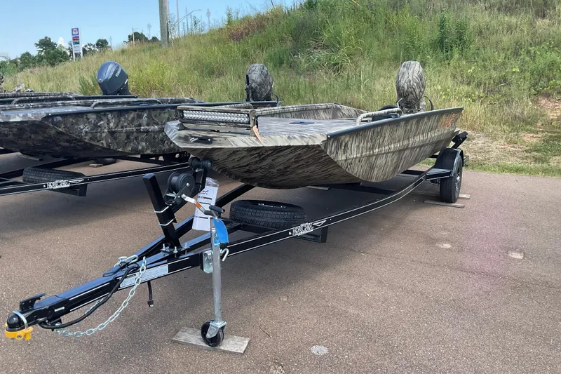 Slide: The Image of 2026 Excel 1751 Viper F4 boat on trailer, camo design, parked on roadside. - 2