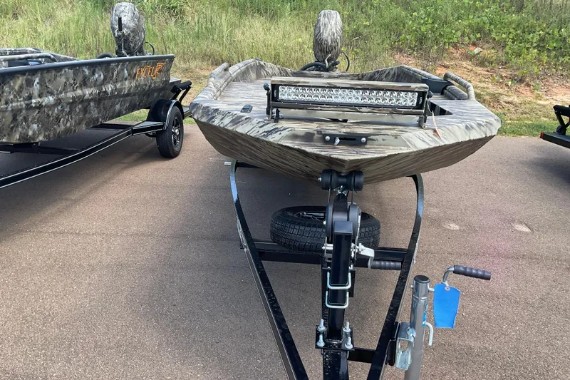 Slide: The Image of 2026 Excel 1751 Viper F4 boat on trailer, camo design, parked on pavement. - 5