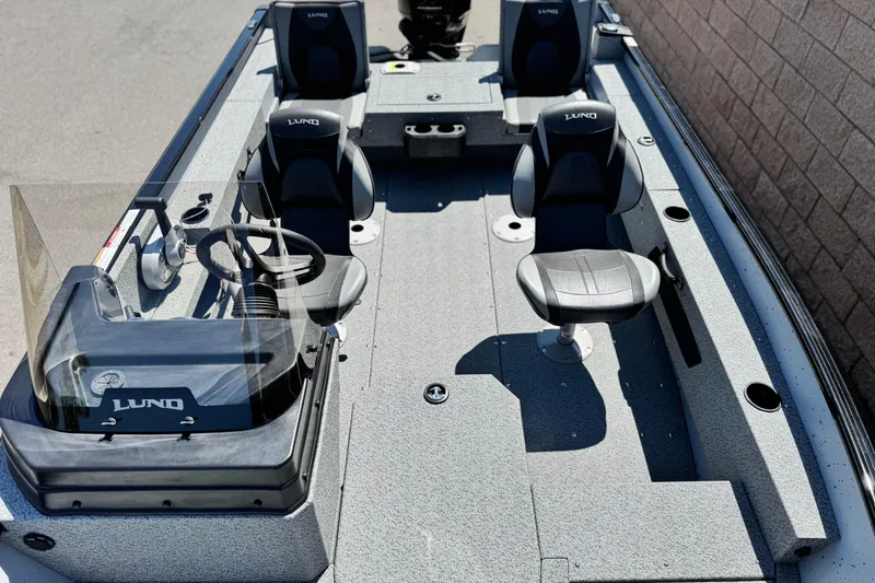 Slide: The Image of 2024 Lund 1775 Adventure Sport boat interior with seating and steering console. - 10