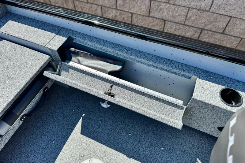 Slide: The Image of 2024 Lund 1775 Adventure Sport boat interior with open storage compartment. - 15