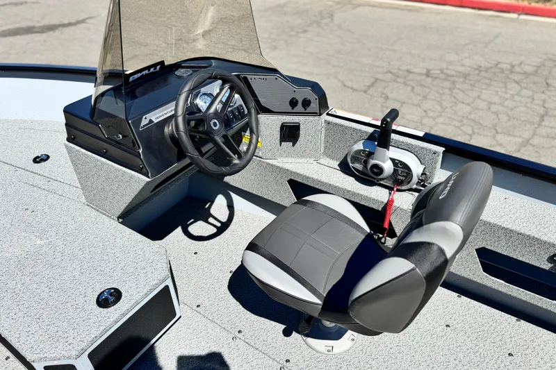 Slide: The Image of 2024 Lund 1775 Adventure Sport boat interior with steering wheel and seat. - 17