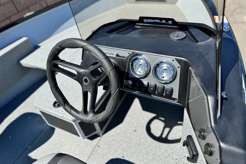 Slide: The Image of 2024 Lund 1775 Adventure Sport boat dashboard with steering wheel and gauges. - 19