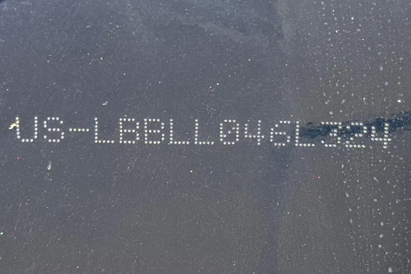 Slide: The Image of 2024 Lund 1775 Adventure Sport hull identification number on dark surface. - 22