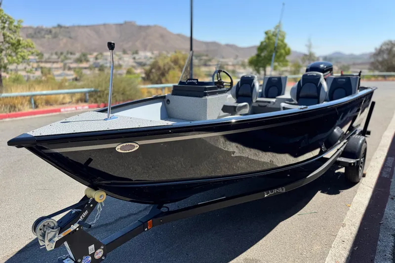 Slide: The Image of 2024 Lund 1775 Adventure Sport boat on trailer, parked outdoors, sunny day. - 3