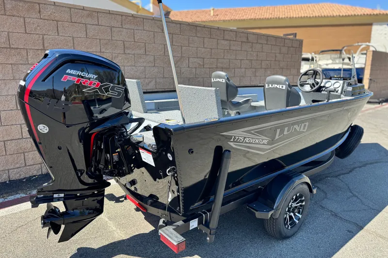 Slide: The Image of 2024 Lund 1775 Adventure Sport boat with Mercury Pro XS engine, parked outdoors. - 4