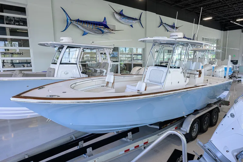 The Image of 2026 Valhalla V-29 boat in showroom, light blue hull, mounted on trailer. - 1