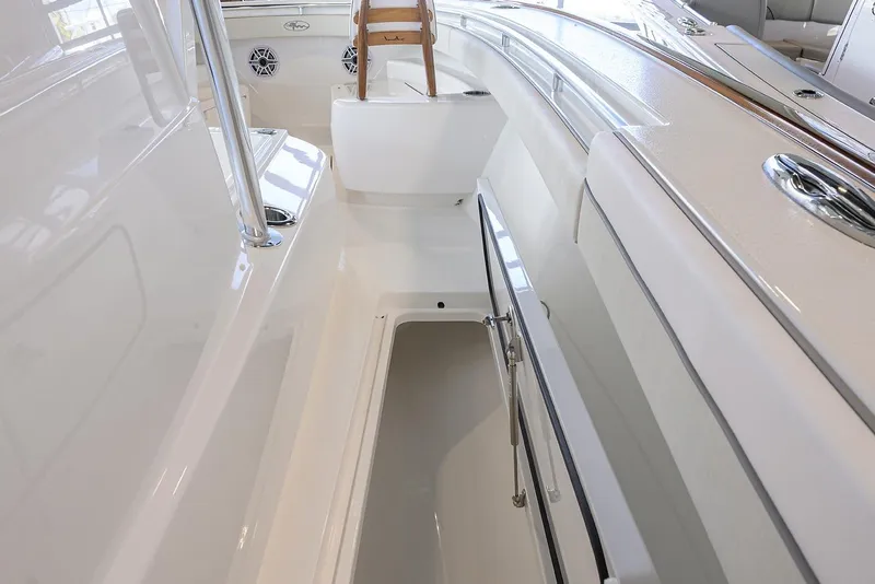 Slide: The Image of 2026 Valhalla V-29 boat interior with sleek white design and storage compartment. - 11