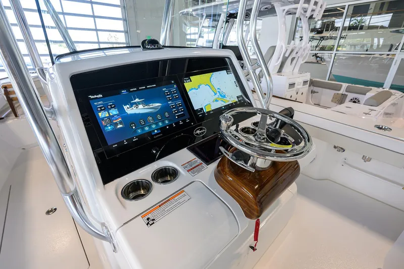 Slide: The Image of 2026 Valhalla V-29 boat dashboard with advanced navigation screens and steering wheel. - 14