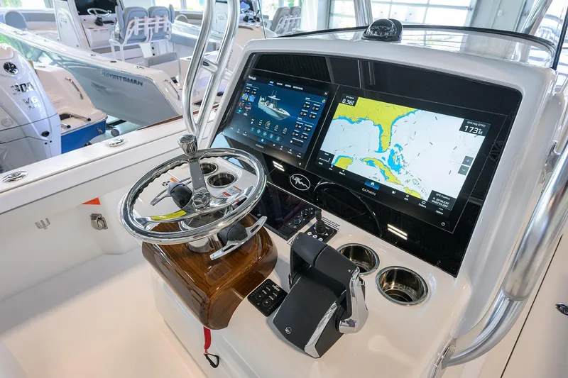 Slide: The Image of 2026 Valhalla V-29 boat dashboard with advanced navigation screens and steering wheel. - 15