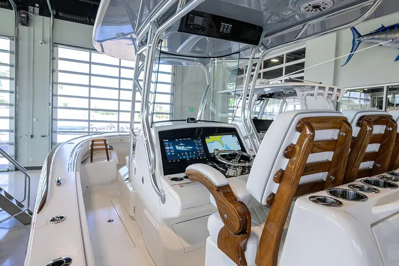 Slide: The Image of 2026 Valhalla V-29 boat interior with modern dashboard and wooden seating. - 17