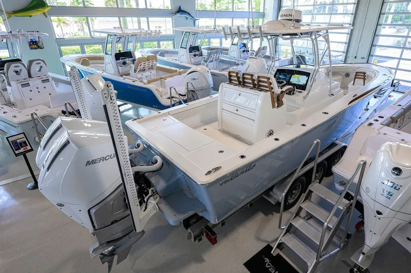 Slide: The Image of 2026 Valhalla V-29 boat displayed in a showroom with other models. - 4