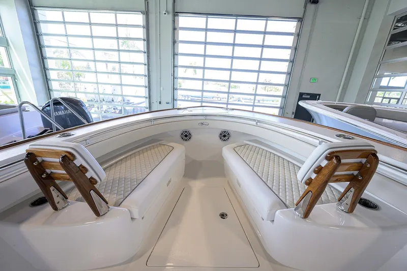 Slide: The Image of 2026 Valhalla V-29 boat interior with cushioned seating and wooden accents in a showroom. - 6