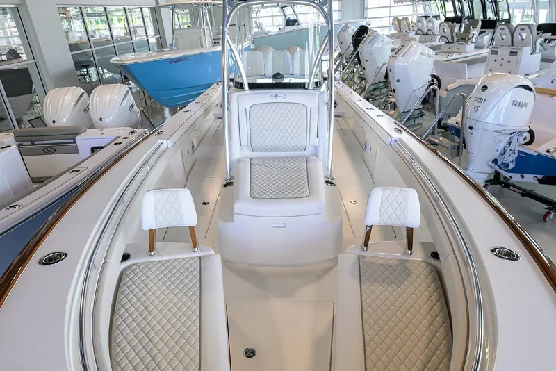Slide: The Image of Luxurious 2026 Valhalla V-29 boat interior with white quilted seating in showroom. - 8