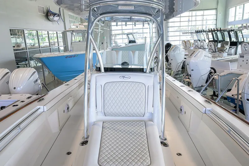 Slide: The Image of 2026 Valhalla V-29 boat interior with white seating and modern design in showroom. - 9