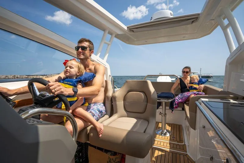 Slide: The Image of Family enjoying a sunny day on a 2023 Nimbus W9 boat. - 16