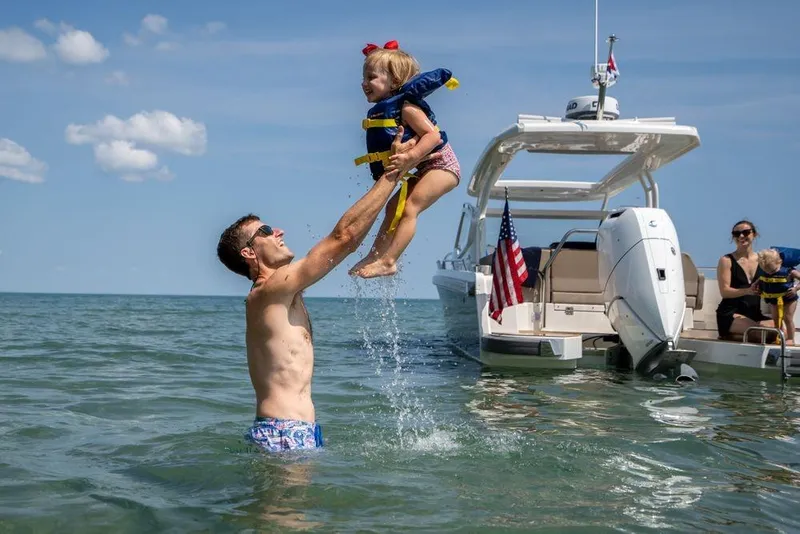 Slide: The Image of Father and child playing in water near 2023 Nimbus W9 boat. - 19