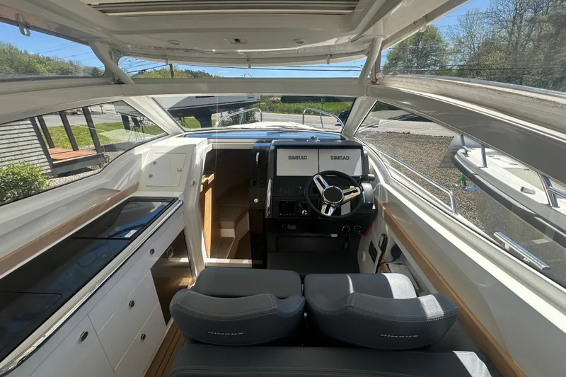 Slide: The Image of Interior of 2023 Nimbus Weekender 9 boat with modern helm and seating. - 24