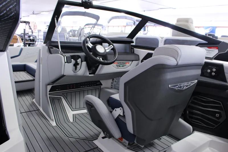Slide: The Image of 2024 Nautique G25 boat interior with modern steering and seating design. - 2