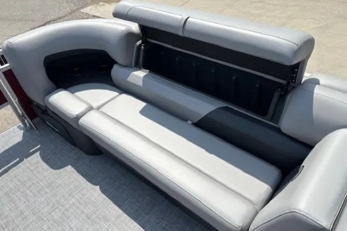 Slide: The Image of 2026 Sun Tracker SportFish 20 DLX boat interior with gray cushioned seating and storage compartment. - 11