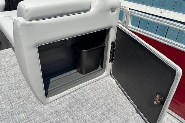 Slide: The Image of 2026 Sun Tracker SportFish 20 DLX boat storage compartment with open door and interior view. - 16