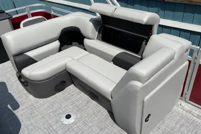 Slide: The Image of 2026 Sun Tracker SportFish 20 DLX pontoon boat with gray seating and storage compartment. - 17