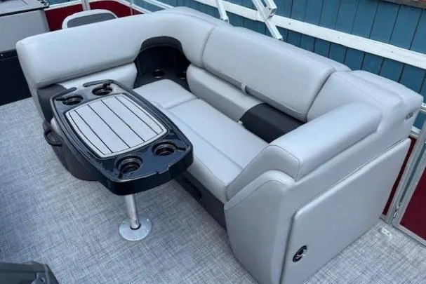 Slide: The Image of 2026 Sun Tracker SportFish 20 DLX boat interior with gray seating and table. - 19