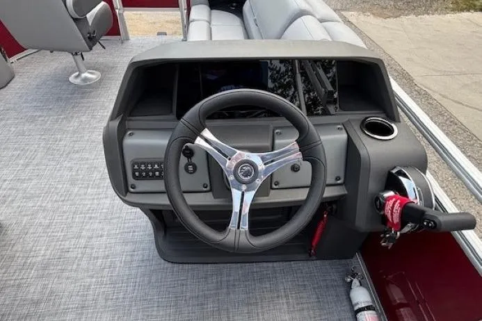 Slide: The Image of 2026 Sun Tracker SportFish 20 DLX boat dashboard with steering wheel and controls. - 21