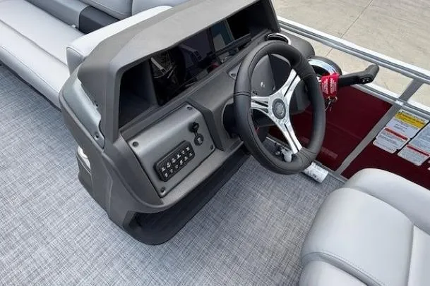 Slide: The Image of 2026 Sun Tracker SportFish 20 DLX boat dashboard with steering wheel and controls. - 23