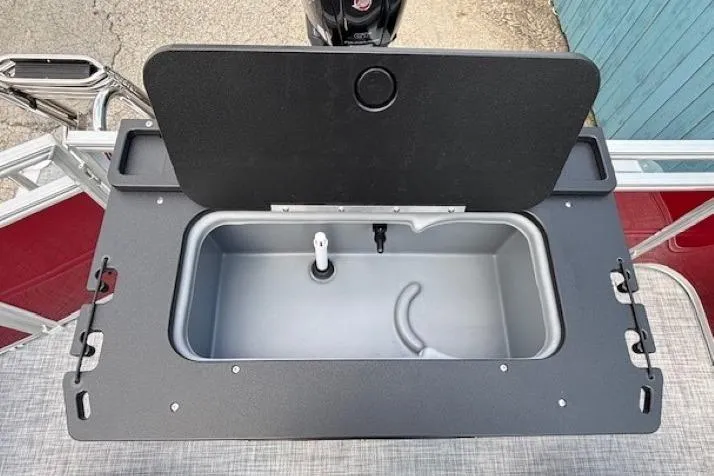 Slide: The Image of 2026 Sun Tracker SportFish 20 DLX livewell with open lid, showcasing interior features. - 27