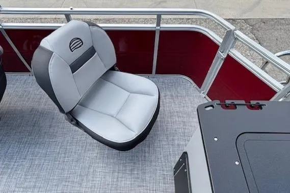 Slide: The Image of 2026 Sun Tracker SportFish 20 DLX boat interior with gray seating and red paneling. - 29
