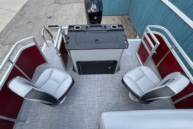 Slide: The Image of 2026 Sun Tracker SportFish 20 DLX pontoon boat interior with seating and control console. - 30