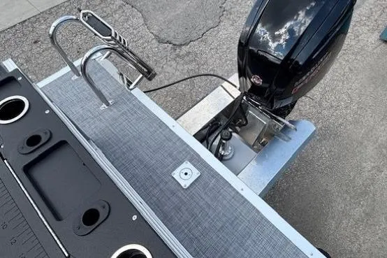 Slide: The Image of 2026 Sun Tracker SportFish 20 DLX boat with motor and swim ladder. - 31