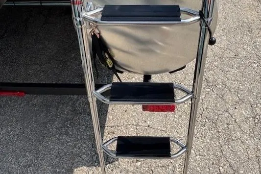 Slide: The Image of Ladder on 2026 Sun Tracker SportFish 20 DLX boat, resting on pavement. - 32