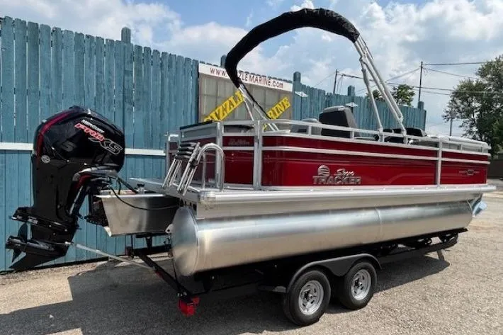 Slide: The Image of 2026 Sun Tracker SportFish 20 DLX pontoon boat on trailer, featuring a powerful outboard motor. - 4
