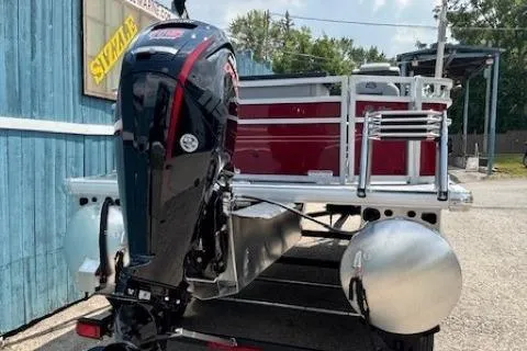 Slide: The Image of 2026 Sun Tracker SportFish 20 DLX pontoon boat with powerful outboard motor, parked outdoors. - 5