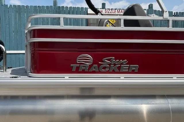 Slide: The Image of 2026 Sun Tracker SportFish 20 DLX pontoon boat with red exterior and logo. - 6