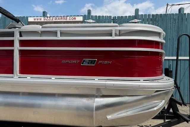 Slide: The Image of 2026 Sun Tracker SportFish 20 DLX pontoon boat with red and white exterior. - 7