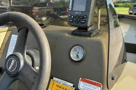 Slide: The Image of 2012 Tracker 1860 Grizzly boat dashboard with steering wheel and Lowrance fish finder. - 6
