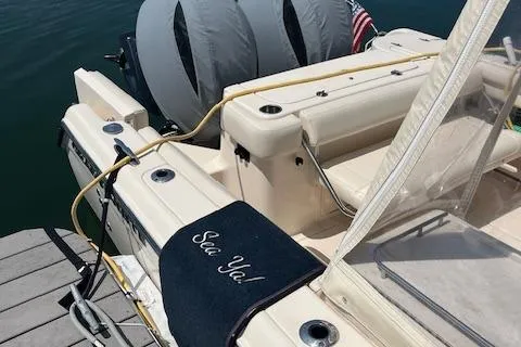 Slide: The Image of 2020 Grady-White Freedom 275 boat docked with twin engines and "Sea Ya!" mat. - 5