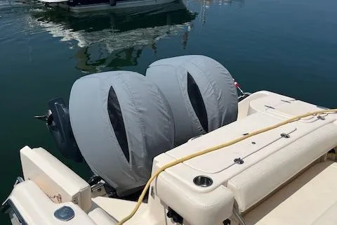 Slide: The Image of 2020 Grady-White Freedom 275 boat with covered outboard motors at a marina. - 6