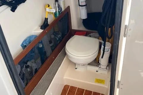 Slide: The Image of 2020 Grady-White Freedom 275 boat interior with toilet and storage area. - 9