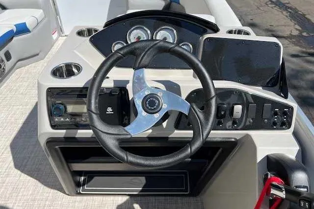 Slide: The Image of 2025 SunCatcher Select 18C boat dashboard with steering wheel and control panel. - 4