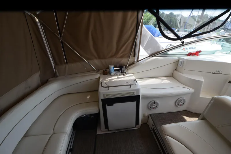 Slide: The Image of Interior of 2000 Larson Cabrio 290 boat with seating and kitchenette area. - 12