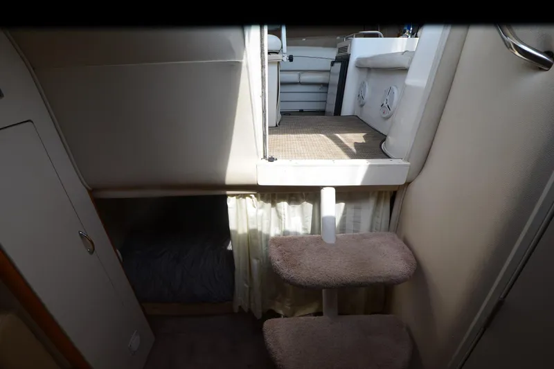 Slide: The Image of Interior of 2000 Larson Cabrio 290 boat with carpeted steps and cozy cabin space. - 19