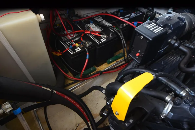 Slide: The Image of Engine compartment of 2000 Larson Cabrio 290 with batteries and wiring. - 22