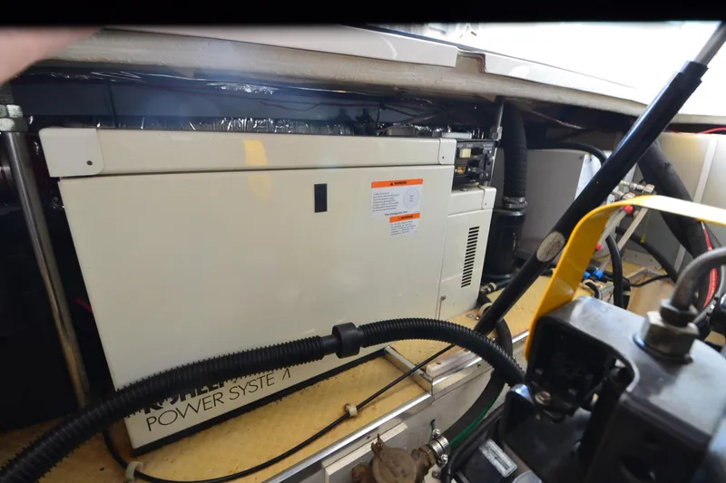 Slide: The Image of Engine compartment of 2000 Larson Cabrio 290 boat, featuring power system components. - 23