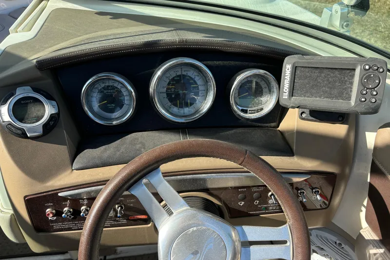 Slide: The Image of Dashboard of a 2011 Sea Ray 210 SLX boat with gauges and navigation equipment. - 10