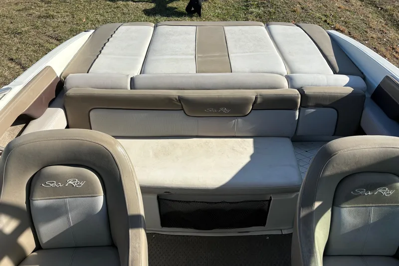 Slide: The Image of 2011 Sea Ray 210 SLX boat interior with beige and gray seating. - 11