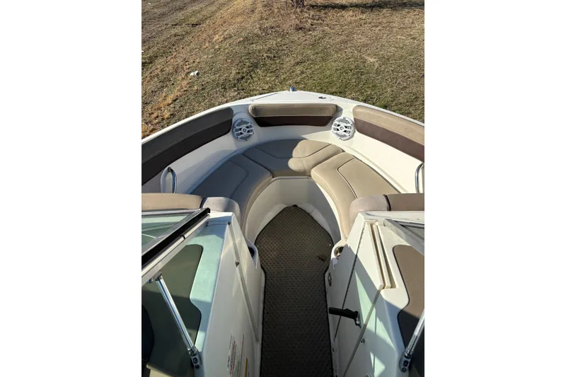 Slide: The Image of 2011 Sea Ray 210 SLX boat interior with cushioned seating and speakers. - 7